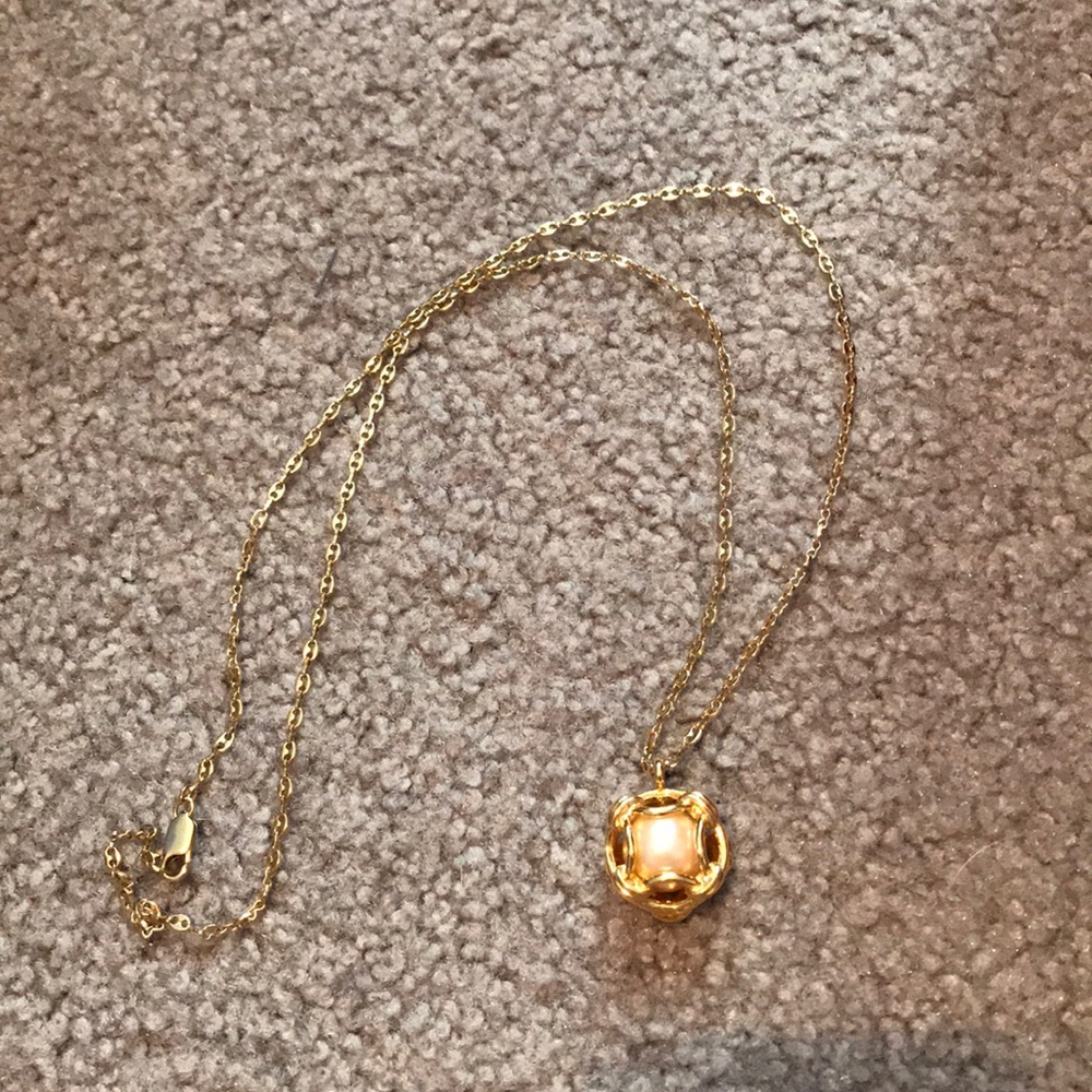 Gold necklace with pearl inside